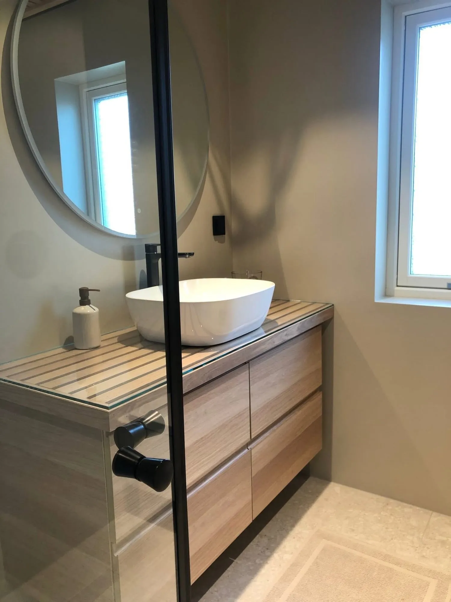 Servantskap i eik med benkeplate av eikespiler under glass